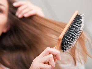 Swap out your metal brush for a paddle or boar bristle brush. The Syndicate suggestion: Aveda Paddle Brush.